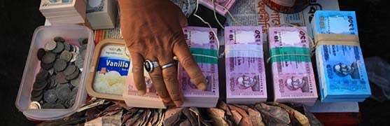 Agent in Bangladesh places stacks of new cash. Photo by Mahfuzul Hasan Bhutan, CGAP Photo Contest