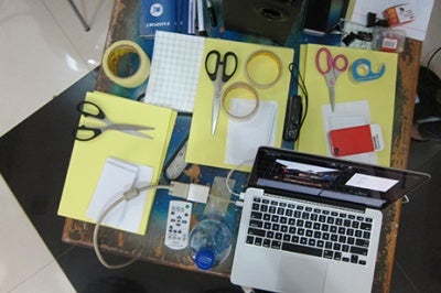 Desk with materials for brainstorming and prototyping sessions, with the goal of delivering financial services targeted to the needs of specific low-income customer segments.