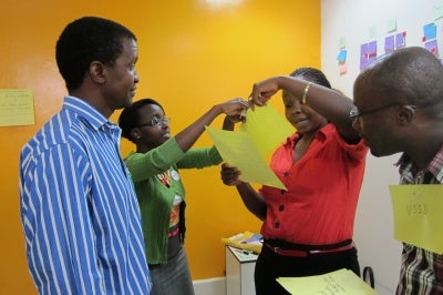 During a workshop with MicroInsure in Kenya, team members discuss ideas about brining customer-centric products and services to low-income customer segments.