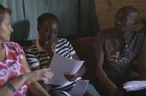 Kenyan woman interviewed for research on a new mobile product by a human-centered design team